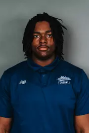 2026 Maine football roster head shot. Blue polo with Maine script.