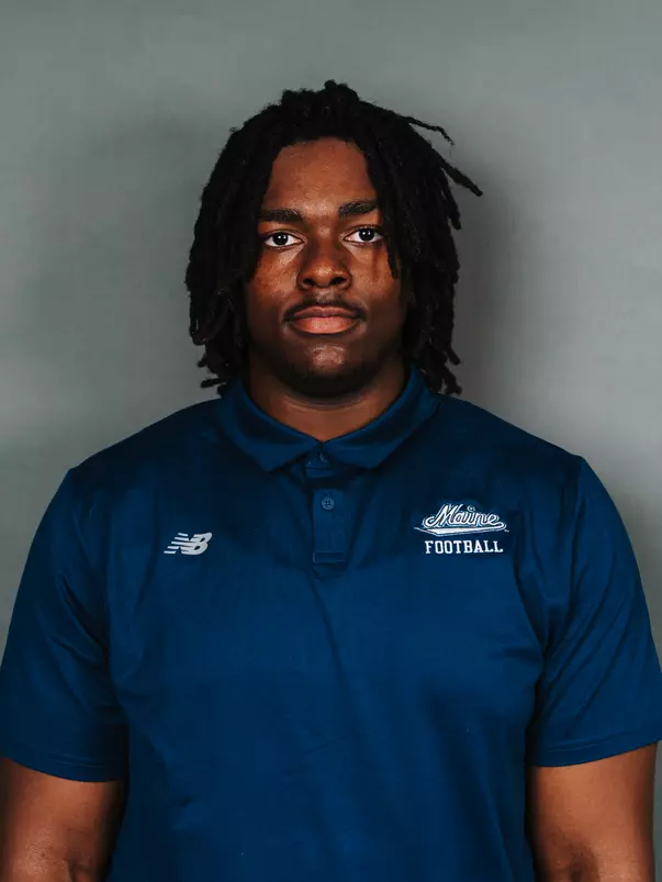 2026 Maine football roster head shot. Blue polo with Maine script.