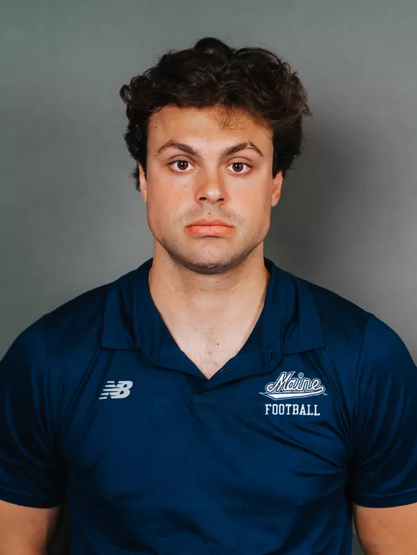 2026 Maine football roster head shot. Blue polo with Maine script.
