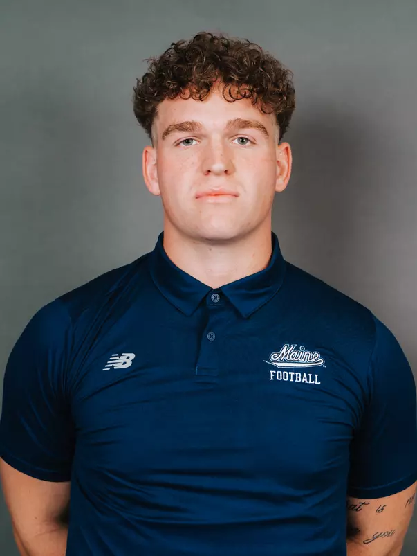 2026 Maine football roster head shot. Blue polo with Maine script.