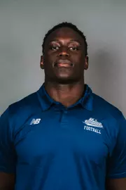 2026 Maine football roster head shot. Blue polo with Maine script.