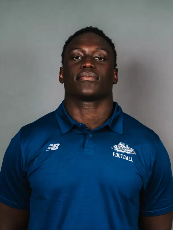 2026 Maine football roster head shot. Blue polo with Maine script.
