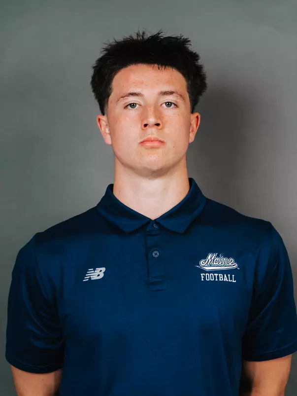 2026 Maine football roster head shot. Blue polo with Maine script.