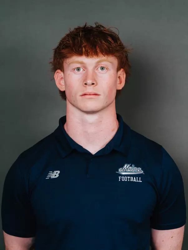2026 Maine football roster head shot. Blue polo with Maine script.