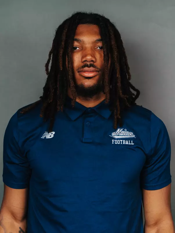 2026 Maine football roster head shot. Blue polo with Maine script.