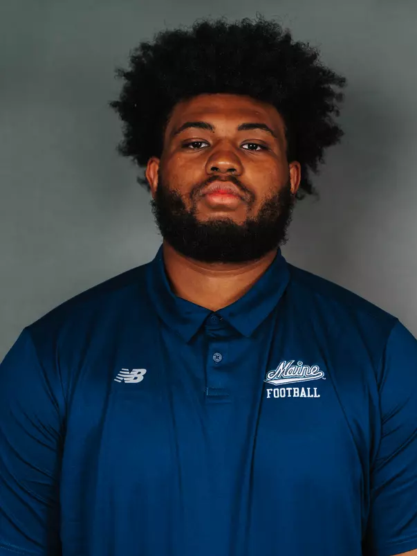 2026 Maine football roster head shot. Blue polo with Maine script.