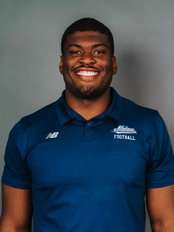 2026 Maine football roster head shot. Blue polo with Maine script.