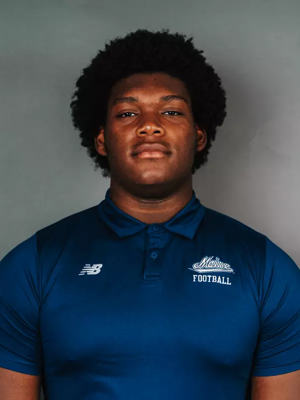 2026 Maine football roster head shot. Blue polo with Maine script.