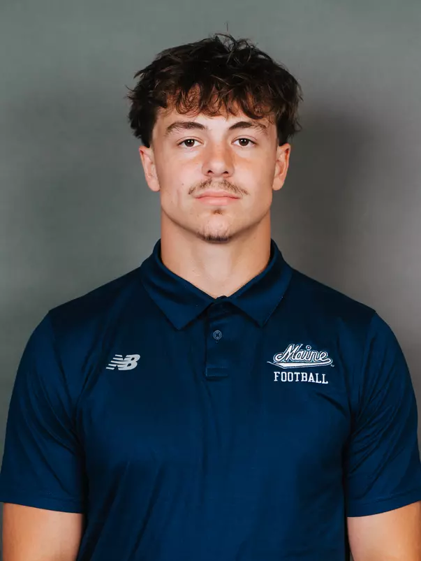 2026 Maine football roster head shot. Blue polo with Maine script.