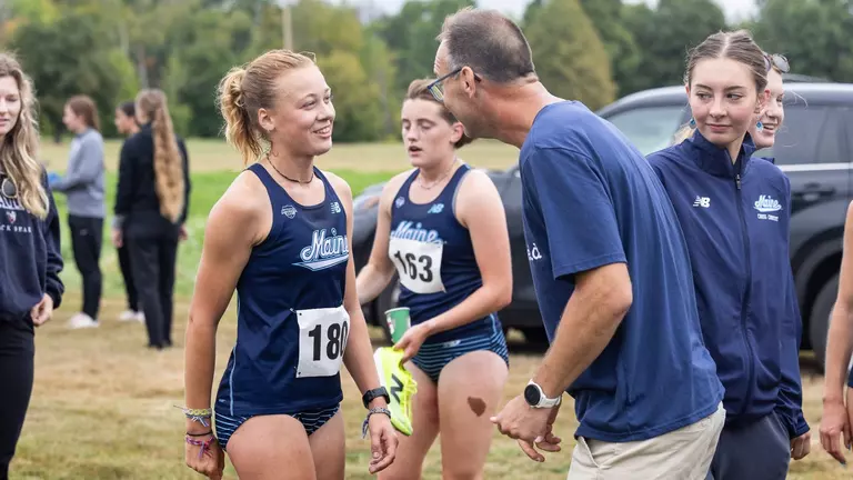Evelyn Wool talking to Coach Adam Ward