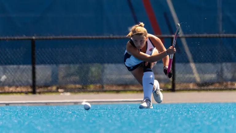 Plaehn strikes the ball with her stick.