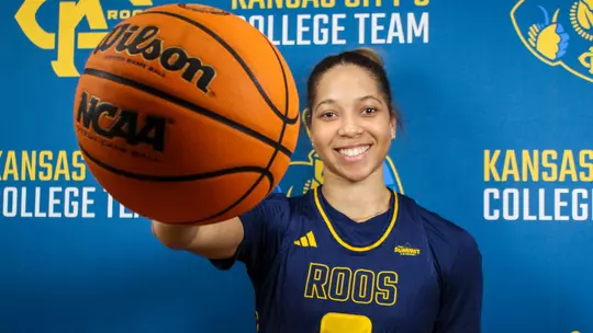 A photo of Lacey Thomas palming the basketball towards the camera
