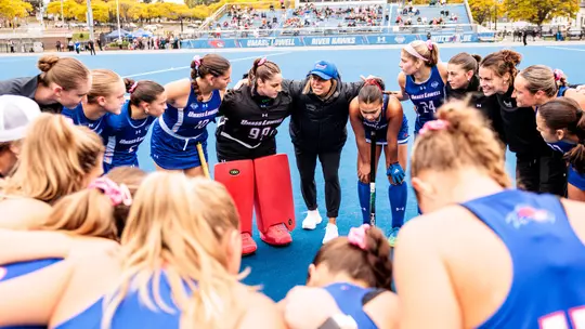 Field Hockey team huddling pregame