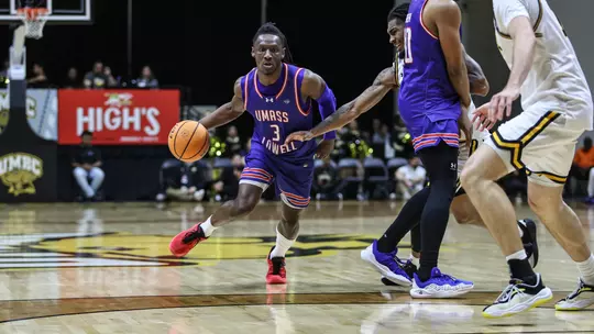 Darrel Yepdo dribbling around a defender at UMBC