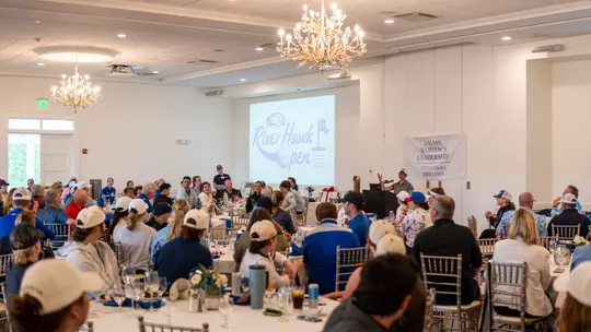 Attendees sitting in ballroom at River Hawk Open