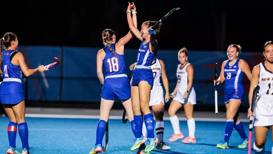 Ella Sluder and Alice Van Hemelen high five