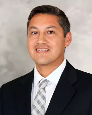 Steve Armas Headshot in front of grey background