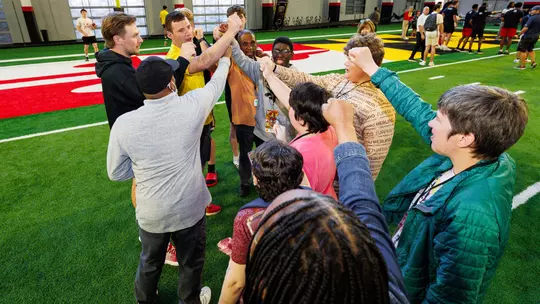 Punter Bryce McFerson with participants from the Beautiful Lives Project event held at the Jones-Hill House indoor on May 5