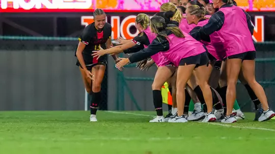 Ella Petry high fives her teammates after scoring her first career goal to tie the match versus Virginia Tech