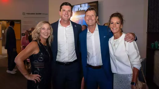 Four people gathered together for a posed photo
