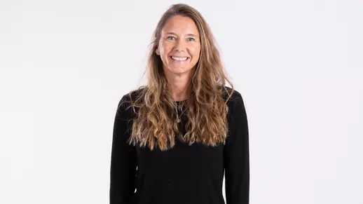 Tara Sunquist smiling on white backdrop