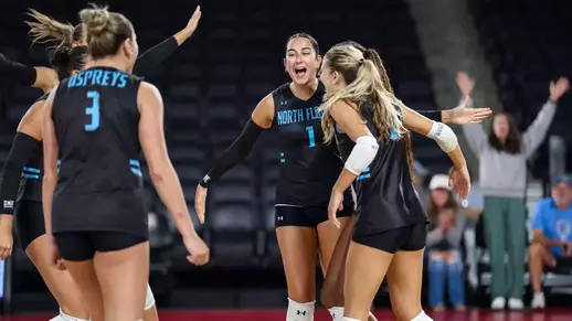 Sofia Dawson celebrates with teammates in group huddle