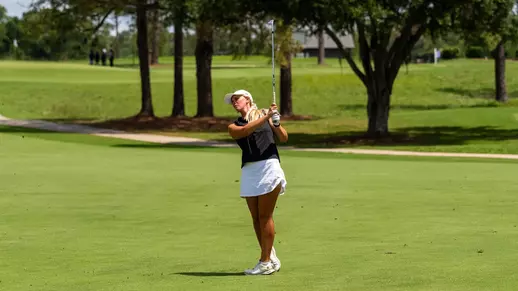 Kaitlyn Schroeder swings her club on a golf course