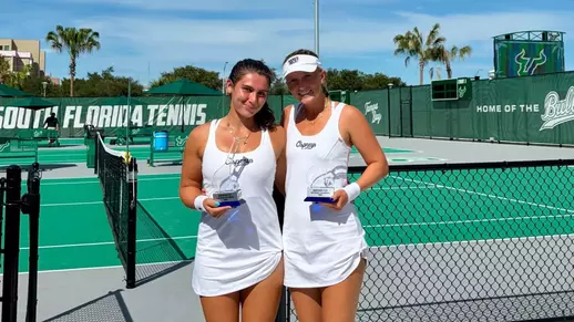 Aryana Bartlett and Gabby Goyins smile for a photo holding trophies