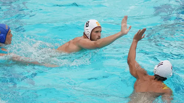 Jake Ehrhardt and Orestis Apergi give each other five in a USC win over UCLA