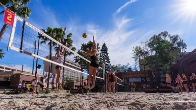 Kaileigh Truslow hits a ball over the net against Pepperdine