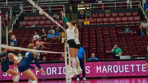 Amelia Wass de Czege with a block against Marquette