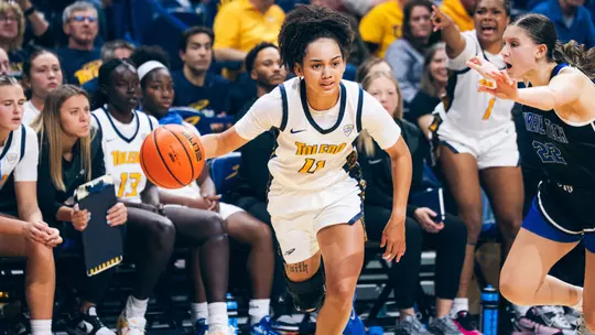 Destiny Robinson dribbles the basketball against Lawrence Tech