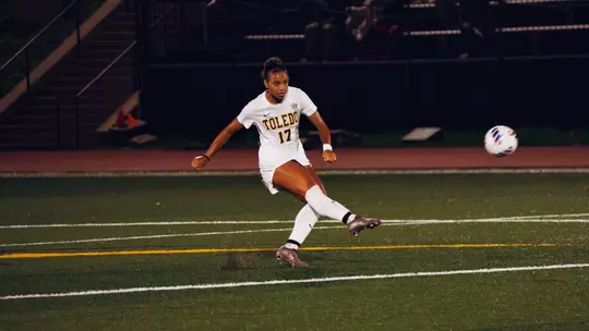 Abby-Lee Sanogo kicks a soccer ball