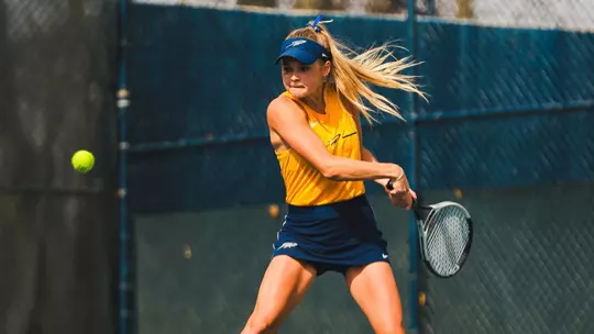 Annika Munson hitting the ball at the UT Varsity Tennis Courts