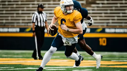 QB John Alan Richter evades a pass rusher at 2026 Spring Game