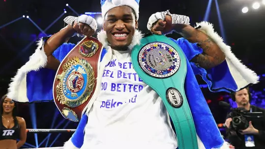 Jared Anderson flexing with championship belts