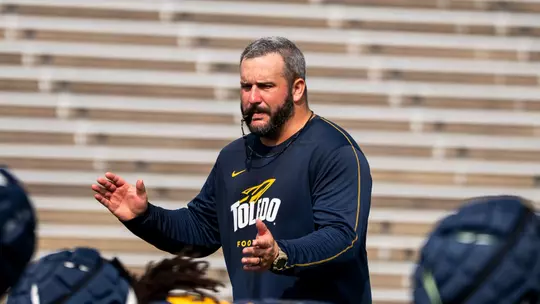 Toledo offensive line coach Brian Folkerts coaching during practice