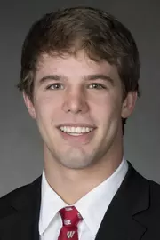 Gabe Grahek headshot in suit