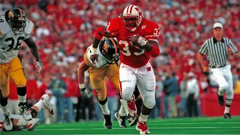 Ron Dayne outracing Iowa during 1999 football game at Camp Randall Stadium