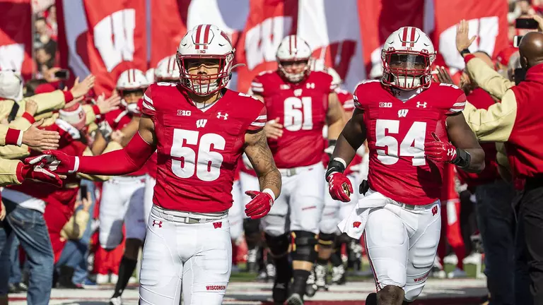 Wisconsin Badgers teammates Zack Baun (56) and Chris Orr (54) lead the team onto the field during an NCAA Big Ten Conference college football game against the Michigan State Spartans Saturday, Oct. 12, 2019, in Madison, Wis. The Badgers won 38-0. (Photo by David Stluka/Wisconsin Athletic Communications)
