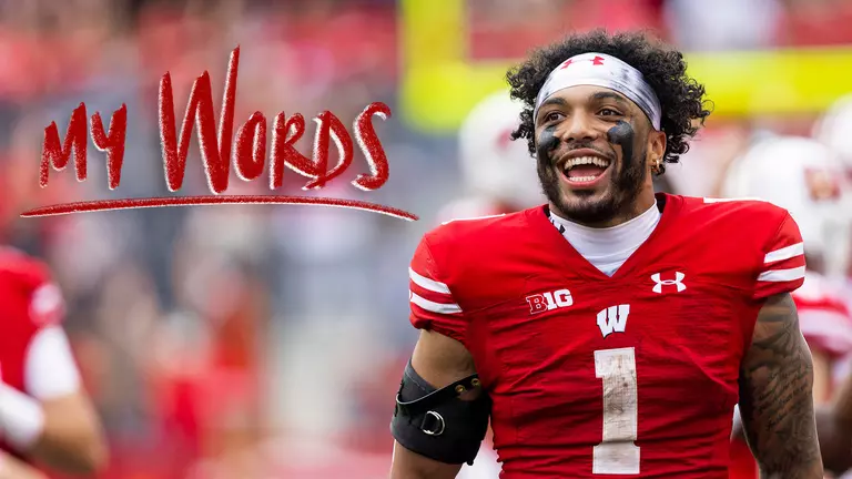 Chez Mellusi, Wisconsin football, smiles in celebration. The "My Words" logo is on the left of the image.