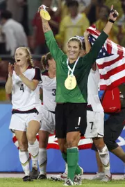 The United States' Rachel Buehler (4) and goalkeeper Hope Solo (1) celebrate aft