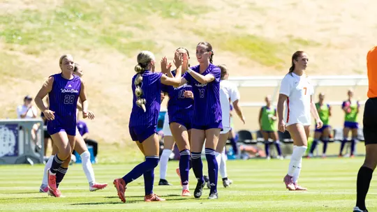 Weber State soccer players celebrating a goal