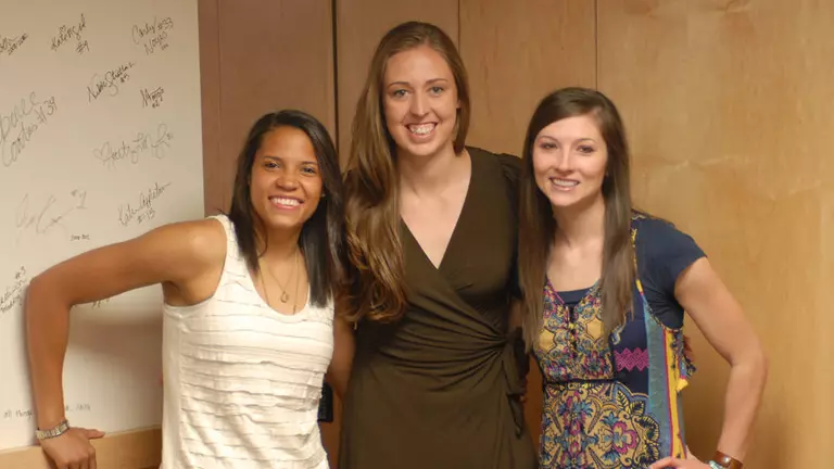 Amojo, Grad and Noyes Sign Senior Wall in Cougar Locker Room