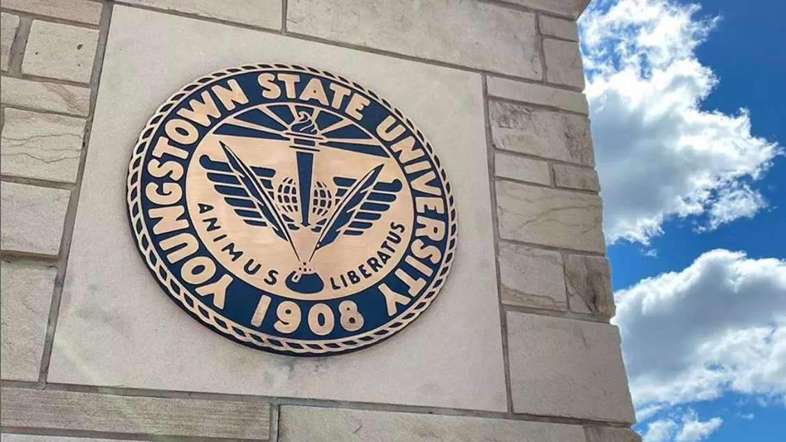 Youngstown State's seal on a pillar on a campus entrance