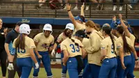 Emma Vickrey crosses home plate to celebrate a walk-off home run with her teammates