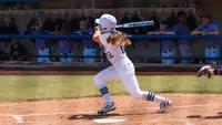 Faith Russell follows through on a home run swing against ECU