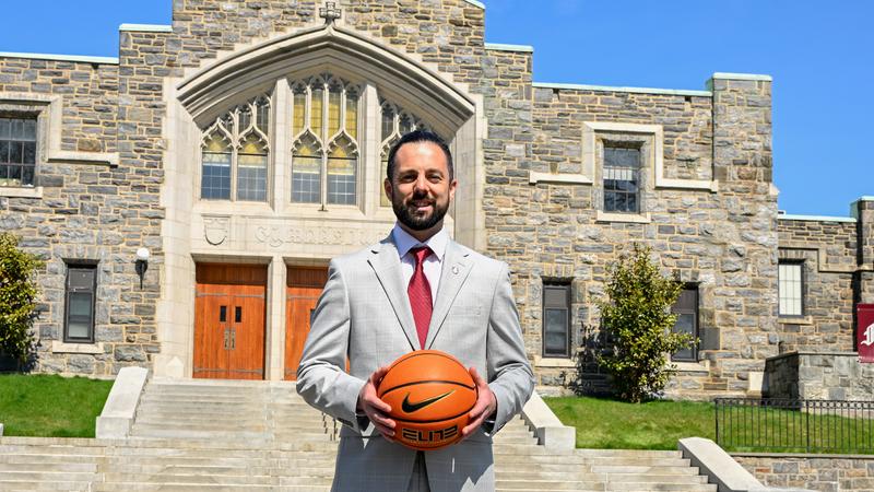 WBB head coach Neal Harrow in front of the Rose Hill Gym