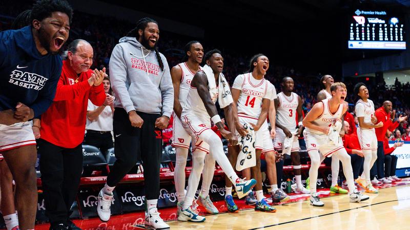 The Dayton men's basketball bench celebrates during the final exhibition of the 2026-27 season against Morehead State.