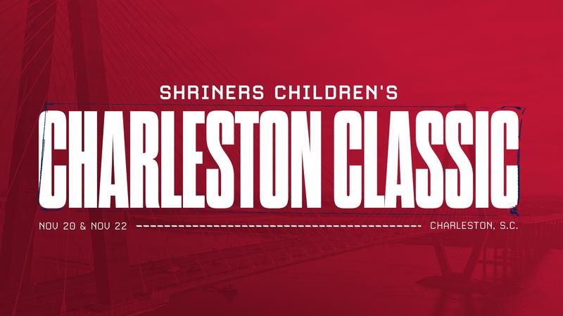 Graphic promoting the Shriners Children's Charleston Classic. Large white text reading “Shriners Children's Charleston Classic” is centered over a red-tinted background featuring the Arthur Ravenel Jr. Bridge spanning Charleston Harbor. The dates “Nov. 20 & Nov. 22” appear in the lower left, and “Ch